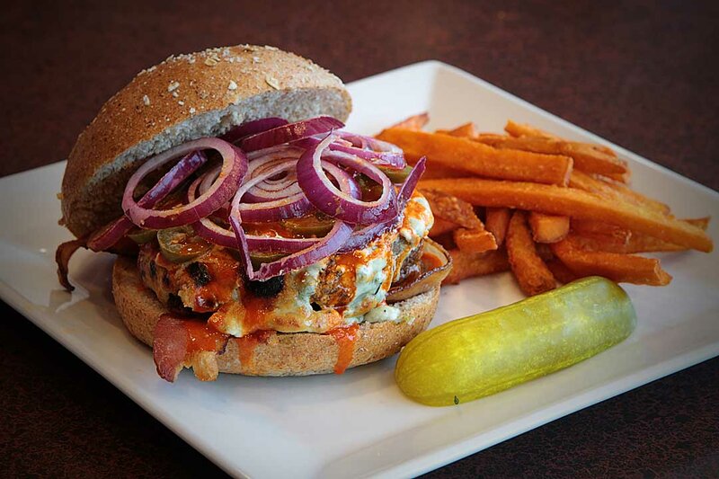 Cheeseburger with side of french fries and pickle