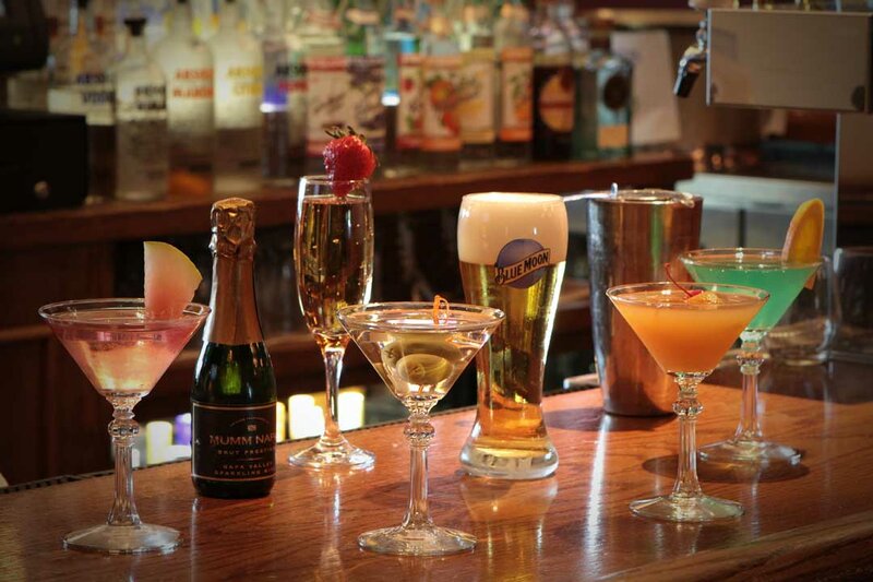 Multiple alcoholic drinks on bar top